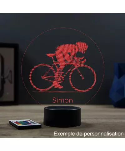 Lampe illusion 3D en verre acrylique gravée au laser représentant un cycliste sur son vélo de course.